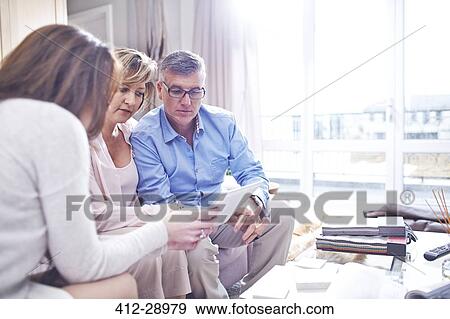 Interior designer using digital tablet in consultation with couple View Large Photo Image Stock Photo - Interior designer using digital tablet in consultation with couple. Fotosearch