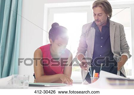 Stock Photograph - Interior designers brainstorming in office. Fotosearch