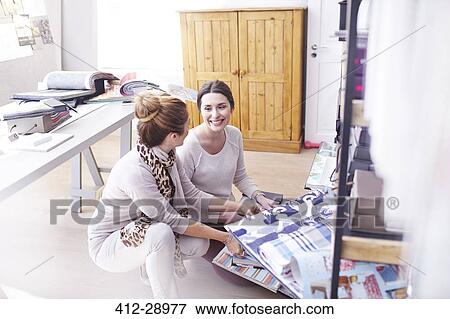 Interior designers browsing fabric swatches in office View Large Photo Image Stock Photo - Interior designers browsing fabric swatches in office. Fotosearch