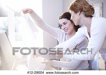Interior designers with digital tablet discussing blueprints in office View Large Photo Image Picture - Interior designers with digital tablet discussing blueprints in office. Fotosearch