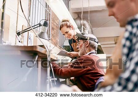 Jeweler and apprentice working in workshop View Large Photo Image Stock Image - Jeweler and apprentice working in workshop. Fotosearch