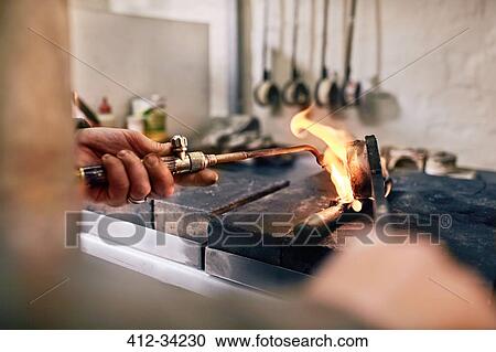 Jeweler heating metal with torch in workshop View Large Photo Image Stock Image - Jeweler heating metal with torch in workshop. Fotosearch