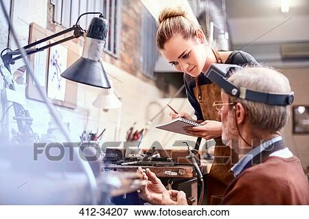 Jeweler teaching apprentice in workshop View Large Photo Image Stock Photo - Jeweler teaching apprentice in workshop. Fotosearch