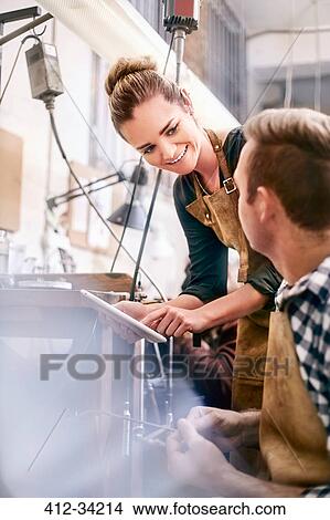 Picture - Jewelers with digital tablet working in workshop. Fotosearch