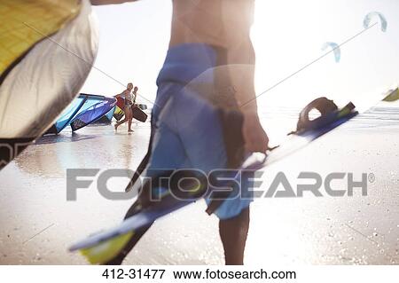 Stock Photo - Kiteboarders on beach. Fotosearch