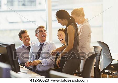 Laughing business people at computer in office View Large Photo Image Stock Image - Laughing business people at computer in office. Fotosearch