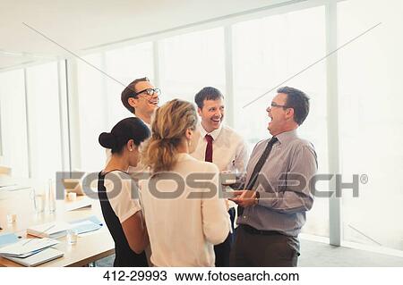 Laughing business people enjoying coffee break in conference room View Large Photo Image Stock Image - Laughing business people enjoying coffee break in conference room. Fotosearch