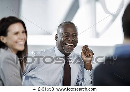 Laughing businessman enjoying meeting View Large Photo Image Stock Photo - Laughing businessman enjoying meeting. Fotosearch