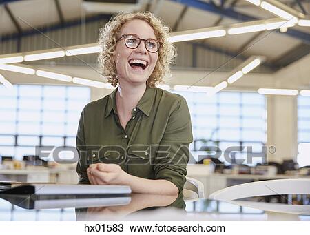 Laughing businesswoman in office View Large Photo Image Stock Image - Laughing businesswoman in office. Fotosearch