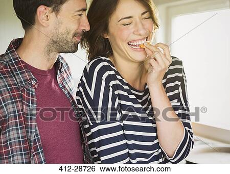Stock Photograph - Laughing couple hugging. Fotosearch