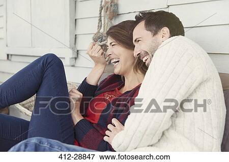 Laughing couple on patio View Large Photo Image Stock Photo - Laughing couple on patio. Fotosearch