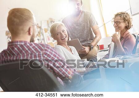 Laughing design professionals meeting in office View Large Photo Image Stock Image - Laughing design professionals meeting in office. Fotosearch