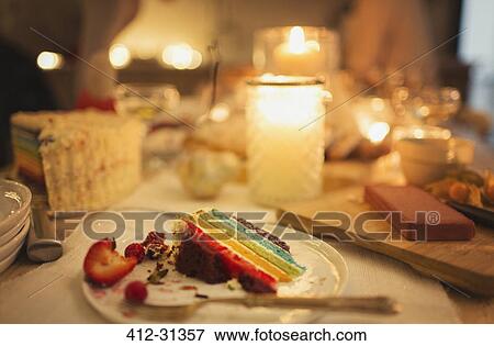Leftover cake on candlelight table View Large Photo Image Stock Photo - Leftover cake on candlelight table. Fotosearch