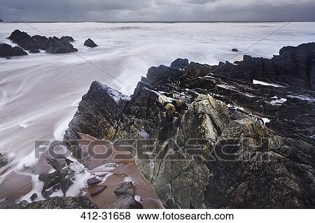 Stock Photo - Long exposure ocean and rocks, Devon, United Kingdom. Fotosearch