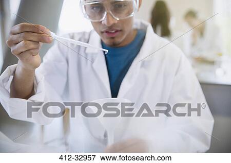 Male college student conducting scientific experiment using pipette in science laboratory classroom View Large Photo Image Stock Photo - Male college student conducting scientific experiment using pipette in science laboratory classroom. Fotosearch