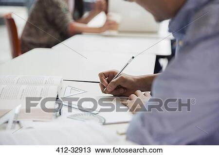 Male college student doing geometry math homework in library View Large Photo Image Stock Image - Male college student doing geometry math homework in library. Fotosearch