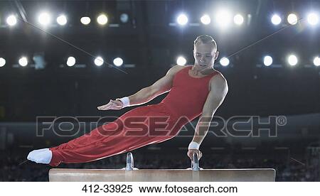 Male gymnast performing on pommel horse in arena View Large Photo Image Stock Photography - Male gymnast performing on pommel horse in arena. Fotosearch