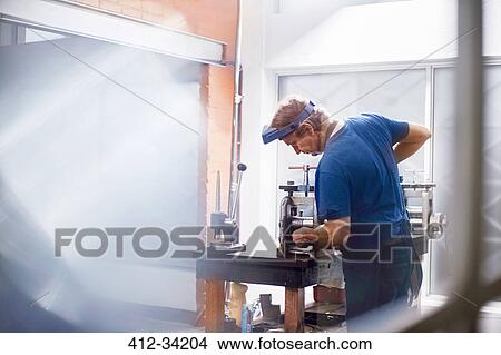 Male jeweler using equipment in jeweler View Large Photo Image Picture - Male jeweler using equipment in jeweler. Fotosearch