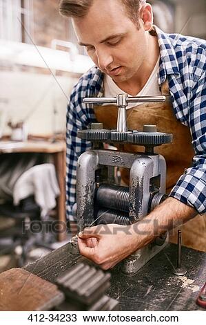 Male jeweler using equipment in workshop View Large Photo Image Stock Image - Male jeweler using equipment in workshop. Fotosearch