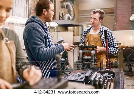 Male jewelers talking and using equipment in workshop View Large Photo Image Stock Image - Male jewelers talking and using equipment in workshop. Fotosearch