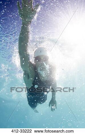 Stock Image - Male swimmer athlete swimming in swimming pool. Fotosearch