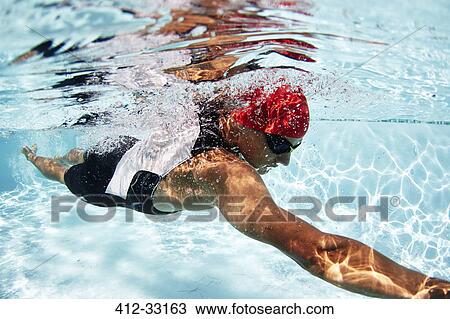 Male swimmer athlete swimming underwater in swimming pool View Large Photo Image Stock Image - Male swimmer athlete swimming underwater in swimming pool. Fotosearch
