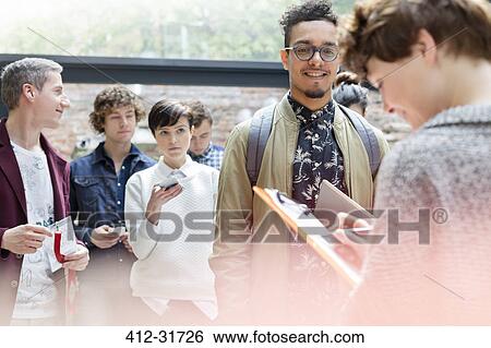 Stock Photograph - Man checking in at technology conference. Fotosearch