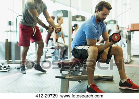 Man doing dumbbell biceps curls at gym View Large Photo Image Stock Photo - Man doing dumbbell biceps curls at gym. Fotosearch
