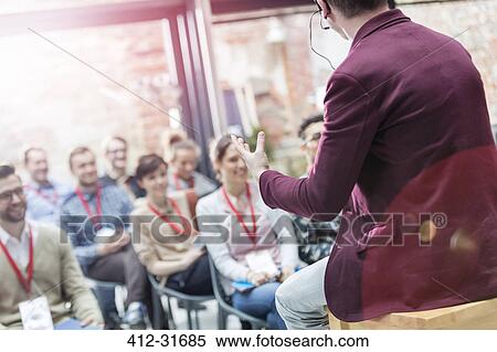 Stock Photography - Man presenting to audience at technology conference. Fotosearch