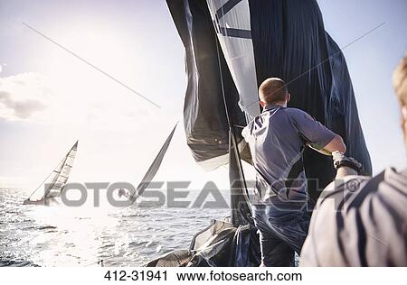 Man sailing on sunny ocean View Large Photo Image Stock Image - Man sailing on sunny ocean. Fotosearch