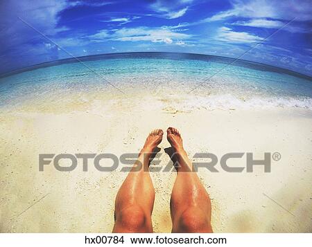 Man sunbathing on sunny tropical beach View Large Photo Image Picture - Man sunbathing on sunny tropical beach. Fotosearch