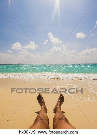 Man sunbathing on sunny tropical beach View Large Photo Image Stock Photo - Man sunbathing on sunny tropical beach. Fotosearch