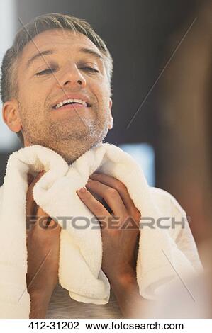 Man wiping neck at bathroom mirror View Large Photo Image Stock Image - Man wiping neck at bathroom mirror. Fotosearch