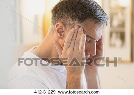 Man with headache rubbing temples View Large Photo Image Stock Photo - Man with headache rubbing temples. Fotosearch