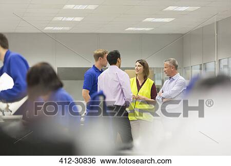 Managers and workers talking in steel factory View Large Photo Image Stock Photograph - Managers and workers talking in steel factory. Fotosearch