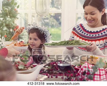 Mother and daughter enjoying Christmas dinner View Large Photo Image Stock Photo - Mother and daughter enjoying Christmas dinner. Fotosearch