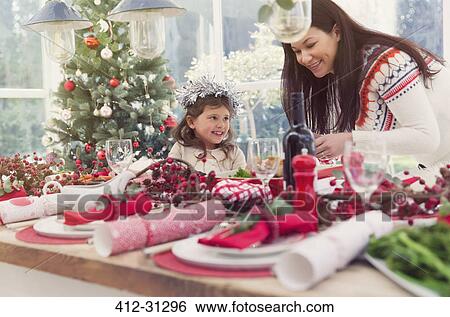 Mother and daughter setting Christmas table View Large Photo Image Stock Photograph - Mother and daughter setting Christmas table. Fotosearch