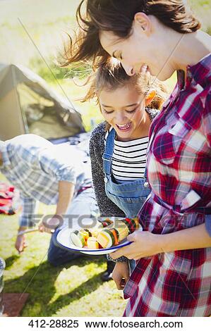 Mother and daughter with vegetable skewers at campsite View Large Photo Image Stock Photography - Mother and daughter with vegetable skewers at campsite. Fotosearch