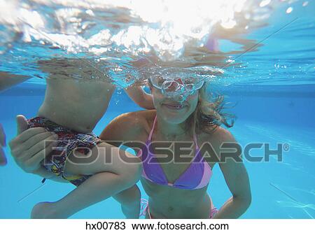 Mother and son swimming underwater in swimming pool View Large Photo Image Stock Image - Mother and son swimming underwater in swimming pool. Fotosearch