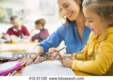 Mother helping daughter with homework View Large Photo Image Stock Image - Mother helping daughter with homework. Fotosearch
