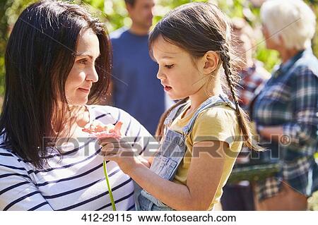 Mother holding daughter with flower View Large Photo Image Stock Photography - Mother holding daughter with flower. Fotosearch