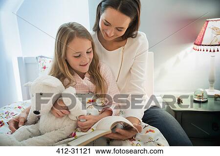 Mother reading bedtime story with daughter in bed View Large Photo Image Stock Image - Mother reading bedtime story with daughter in bed. Fotosearch