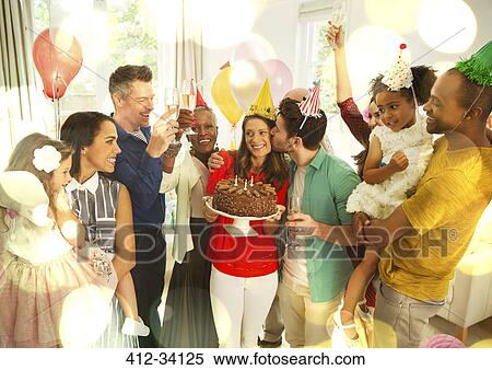 Multi-ethnic multi-generation family celebrating birthday with chocolate cake View Large Photo Image Stock Photography - Multi-ethnic multi-generation family celebrating birthday with chocolate cake. Fotosearch