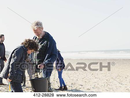 Multi-generation family clam digging on sunny beach View Large Photo Image Stock Photo - Multi-generation family clam digging on sunny beach. Fotosearch