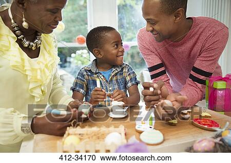 Multi-generation family decorating Easter eggs and cookies View Large Photo Image Stock Image - Multi-generation family decorating Easter eggs and cookies. Fotosearch