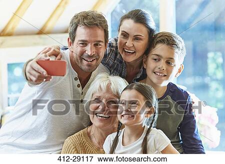 Multi-generation family taking selfie View Large Photo Image Stock Photo - Multi-generation family taking selfie. Fotosearch