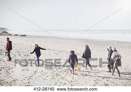 Multi-generation family walking on sunny beach View Large Photo Image Stock Image - Multi-generation family walking on sunny beach. Fotosearch