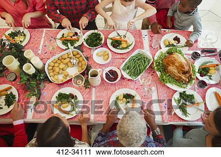 Overhead view family eating Christmas dinner View Large Photo Image Stock Image - Overhead view family eating Christmas dinner. Fotosearch