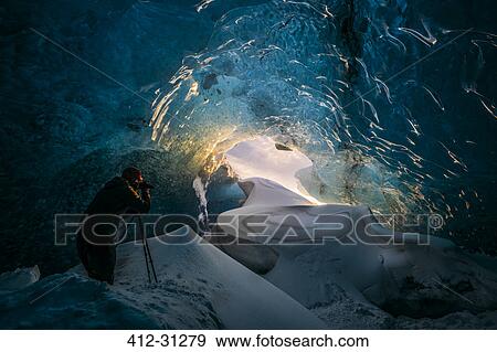 Photographer in ice cave, Iceland View Large Photo Image Stock Photo - Photographer in ice cave, Iceland. Fotosearch
