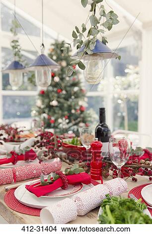 Placesetting and Christmas decorations on dining table View Large Photo Image Picture - Placesetting and Christmas decorations on dining table. Fotosearch